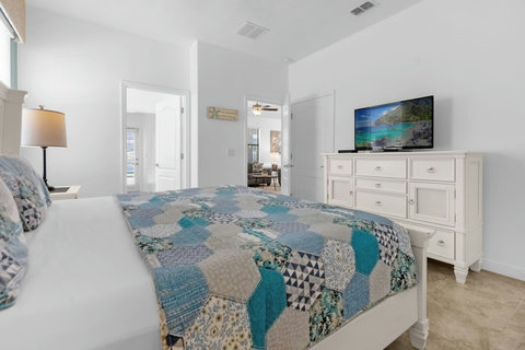 King size bed and en suite bathroom with door to the pool area
