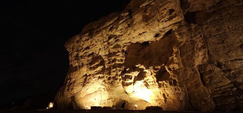Lights on sand stone cliffs surrounding home. 