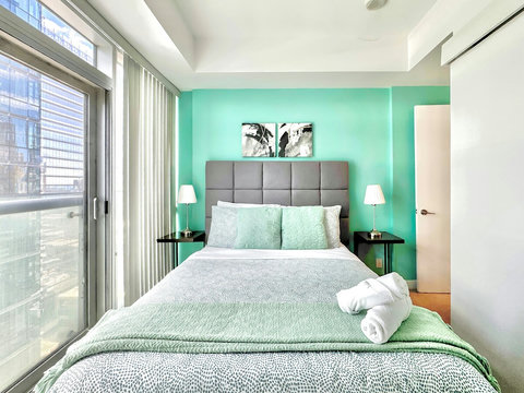 Rest and recharge in a serene bedroom featuring a plush queen-size bed, soft linens, ample storage, a Smart TV, and a private full-size bathroom. Enjoy the perfect blend of comfort, entertainment, and privacy in your own peaceful retreat.