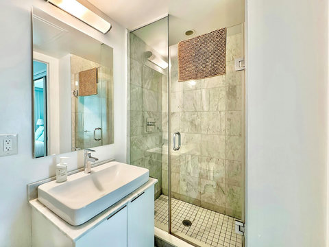 Refresh and unwind in a modern full-size bathroom featuring a sleek shower, clean fixtures, and essential toiletries. Thoughtfully designed for comfort and convenience, it’s the perfect spot to start your day or relax after a long one.