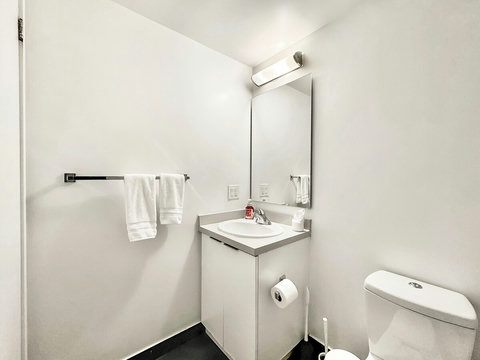 Refresh and unwind in a modern full-size bathroom featuring a sleek shower, clean fixtures, and essential toiletries. Thoughtfully designed for comfort and convenience, it’s the perfect spot to start your day or relax after a long one.