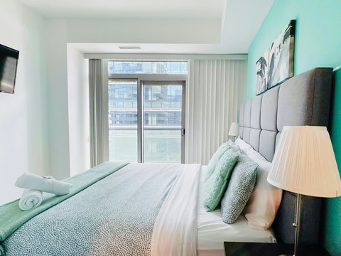 Rest and recharge in a serene bedroom featuring a plush queen-size bed, soft linens, ample storage, a Smart TV, and a private full-size bathroom. Enjoy the perfect blend of comfort, entertainment, and privacy in your own peaceful retreat.