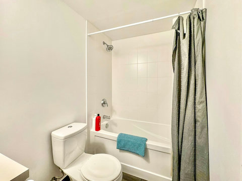 Refresh and unwind in a modern full-size bathroom featuring a sleek shower, clean fixtures, and essential toiletries. Thoughtfully designed for comfort and convenience, it’s the perfect spot to start your day or relax after a long one.