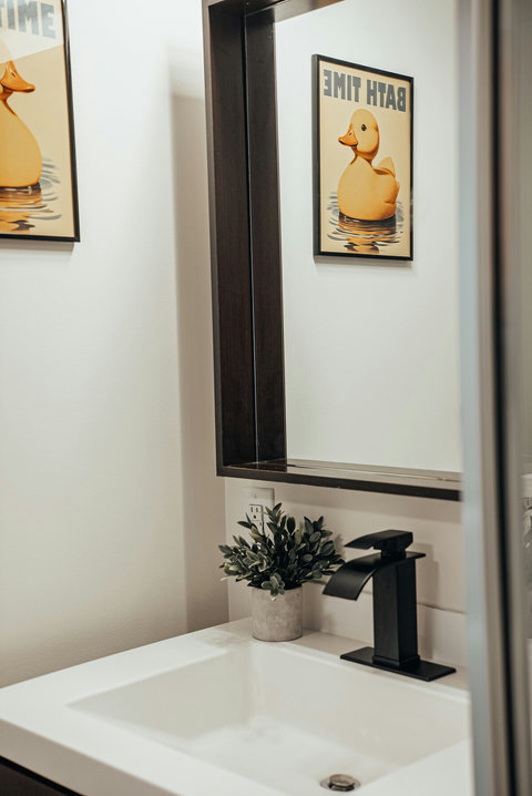 Bright and functional bathroom with a well-lit mirror and sink area
