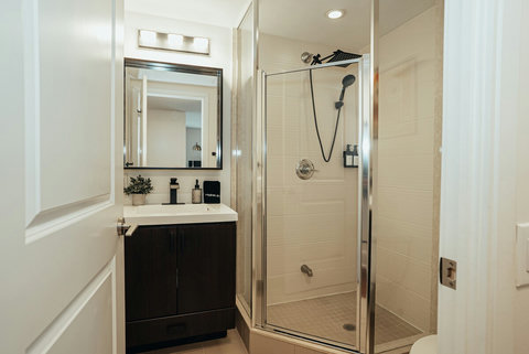Bright and functional bathroom with a well-lit mirror and sink area. Essential toiletries are provided for your convenience.