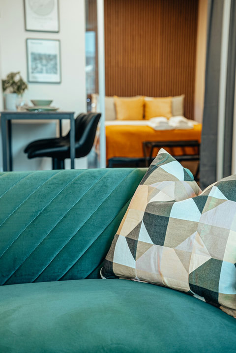 Unwind in style! Sink into our comfortable green velvet sofa and enjoy your favorite shows with lightning-fast 4K streaming on our smart TV.
