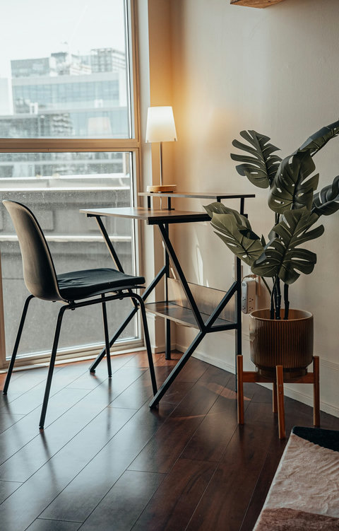 Bright workspace with a comfortable desk and charging cables provided free of charge