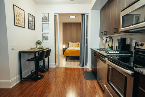 Modern kitchen with a stylish bar table, perfect for casual meals or drinks. Enjoy a quick breakfast before heading out to explore Toronto