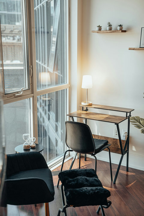 Sun-drenched desk area and a comfortable reading nook by the floor-to-ceiling window. Perfect for work or unwinding with a book