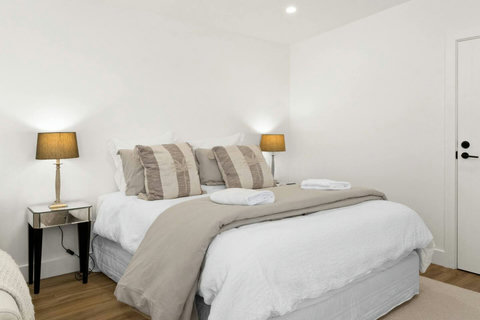 Peaceful sanctuary – soft bedding, calming tones, and restful sleep await you.