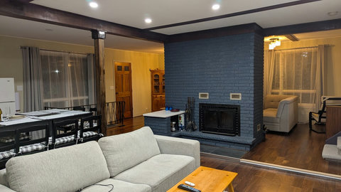 Open-concept living room and kitchen with a sectional and a sofa bed.