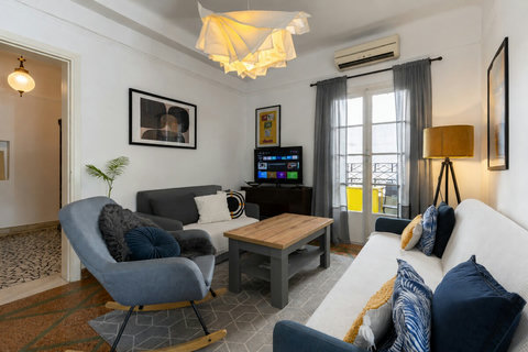 Bright living room with air conditioning, comfortable seating and direct access to the private balcony.