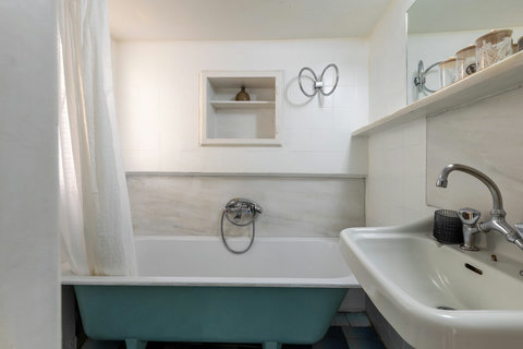 Bathroom with bathtub and shower.