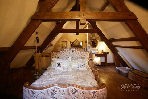 The master bedroom looks out over old Walnut trees. It has its own loo and a freestanding bath for two.