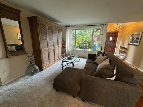 Living Room: Bright and airy space with stylish decor and inviting view