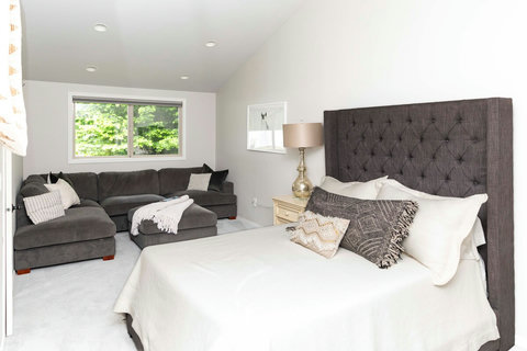 Comfortable primary bedroom with vaulted ceilings