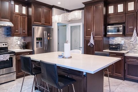 Spacious full kitchen, with fridge, dishwasher, air fryer, microwave, kettle, and dry storage.  